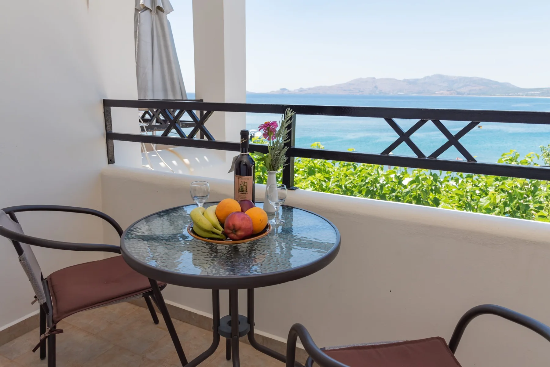 Private balcony with a table overlooking the sea